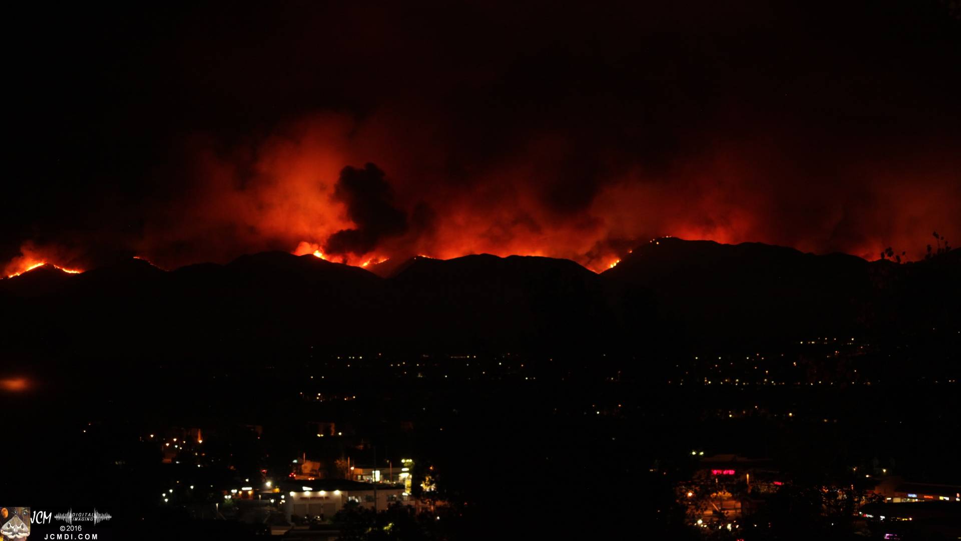 Sand fire long-exposure night image with bloody moonrise JCMDI.COM